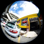 Fisheye exterior view of the shop and cars in the lot